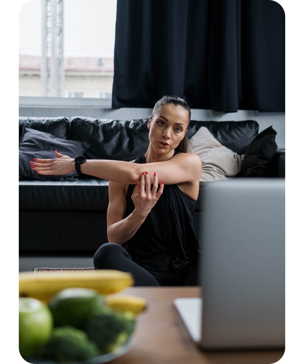 Woman doing physical therapy exercise in front of her laptop